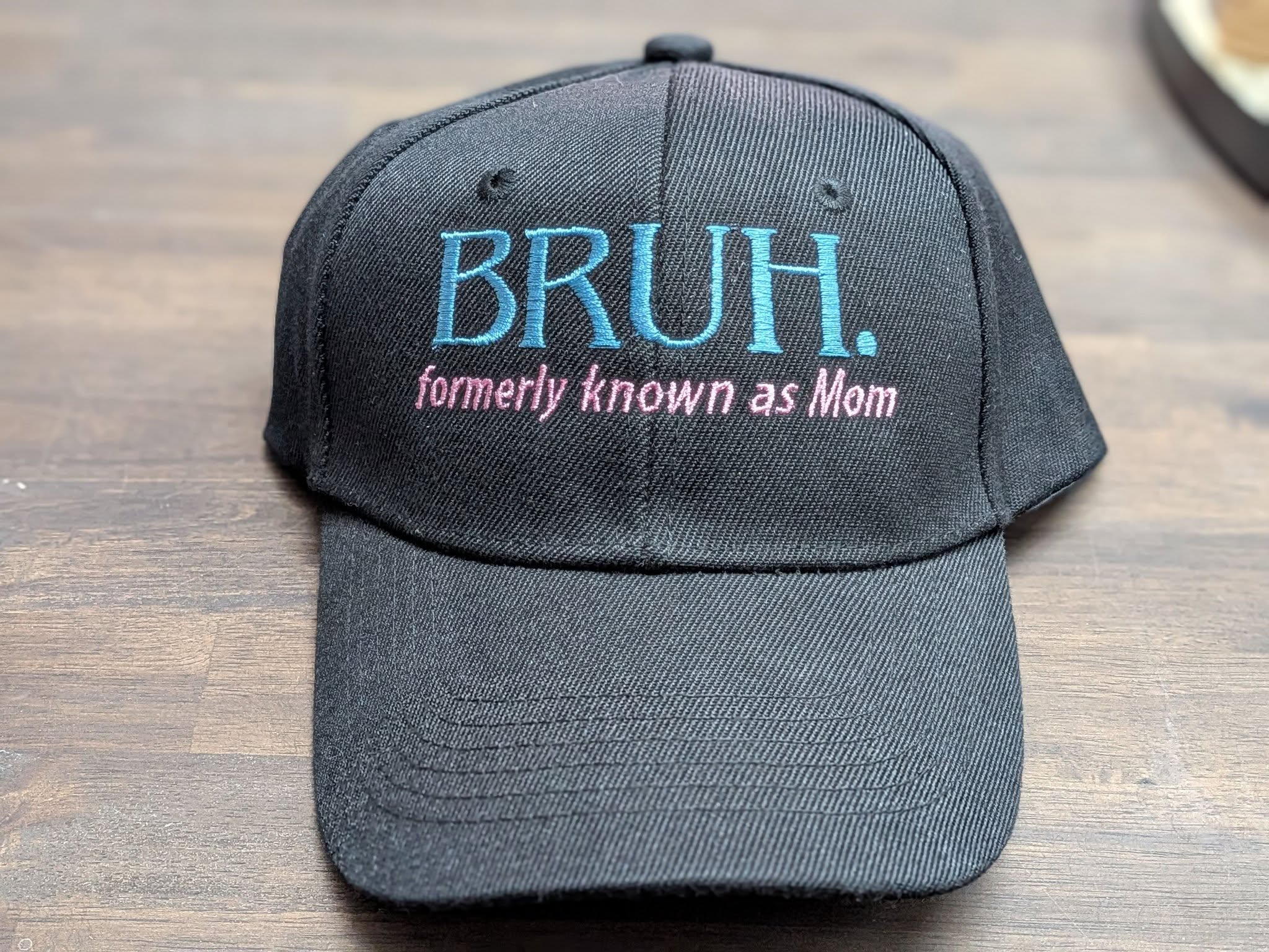 Embroidered black cap reading BRUH. formerly known as Mom